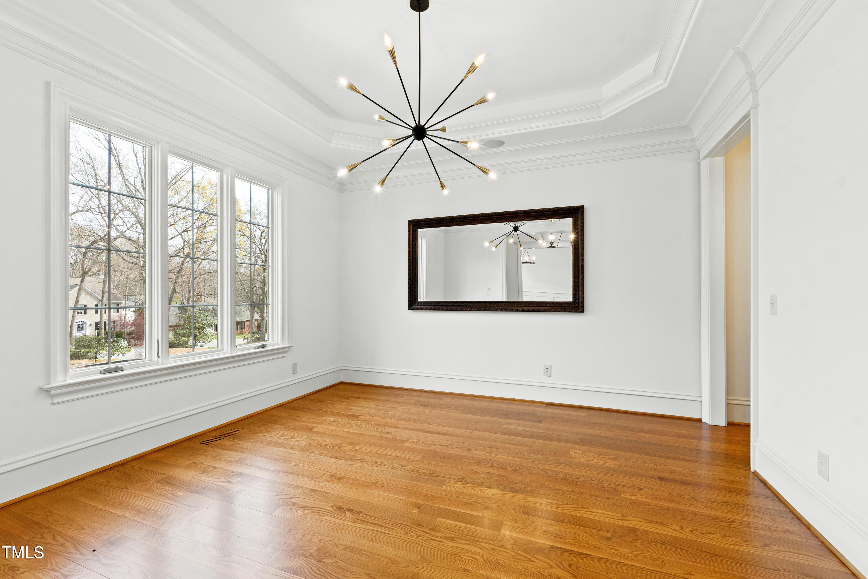 8108 Harps Mill Road Raleigh, NC 27615 - Photo 9 of 64 a view of a room with wooden floor and a window
