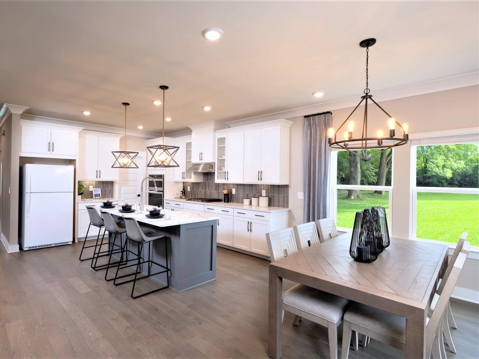692 Castle Road Mount Juliet, TN 37122 - Photo 7 of 19 a dining room with stainless steel appliances a dining table chairs and large windows