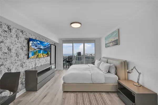 a living room with furniture a rug and a flat screen tv