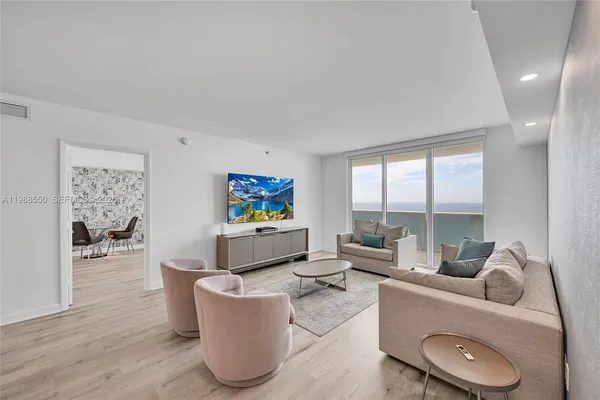 a living room with furniture and a flat screen tv