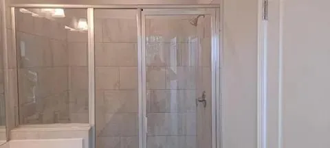 a bathroom with a glass shower door