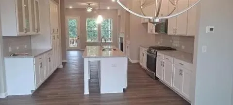 a kitchen with stainless steel appliances a white stove top oven and a refrigerator