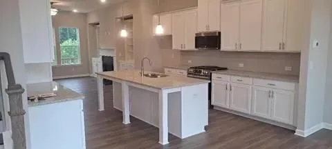 a kitchen with a sink stove and cabinets
