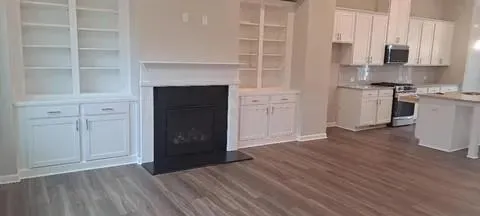 a view of kitchen with granite countertop cabinets and wooden floor