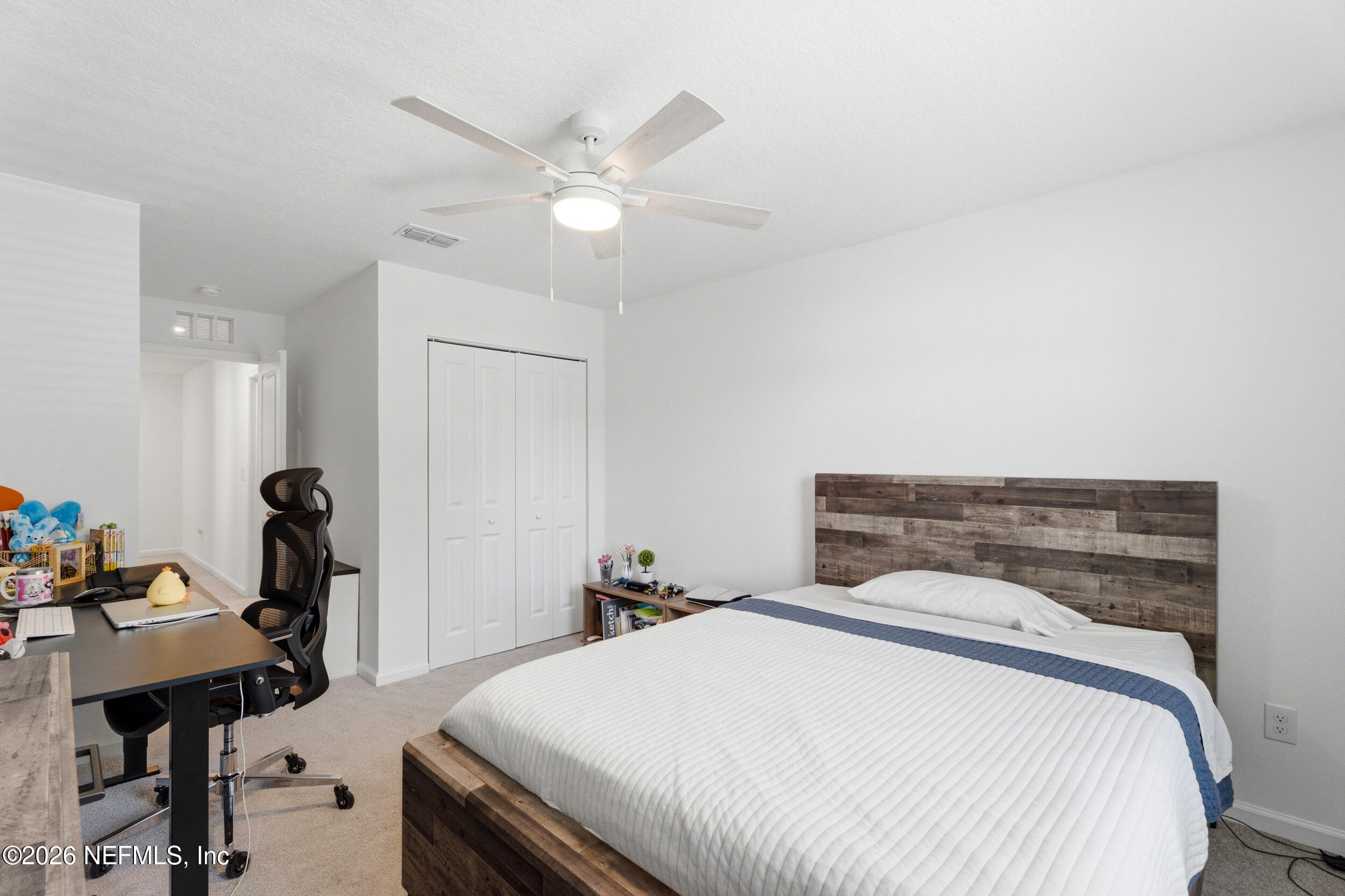 1615 Cluny Road Jacksonville, FL 32218 - Photo 14 of 18 a bedroom with a bed and a table in it