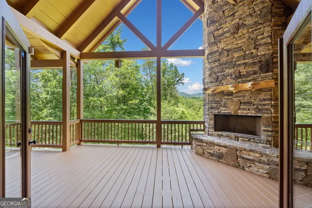 a view of a porch with wooden floor and furniture