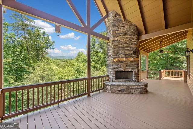 a view of a porch with furniture and floor to ceiling window
