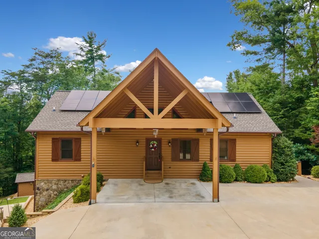 a front view of a house with a garden and garage
