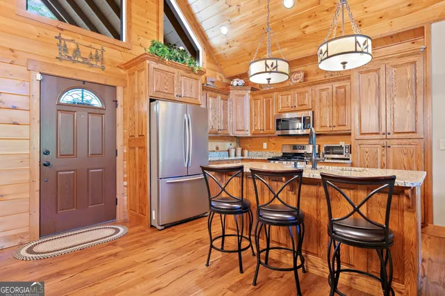 a view of a kitchen with table and chairs