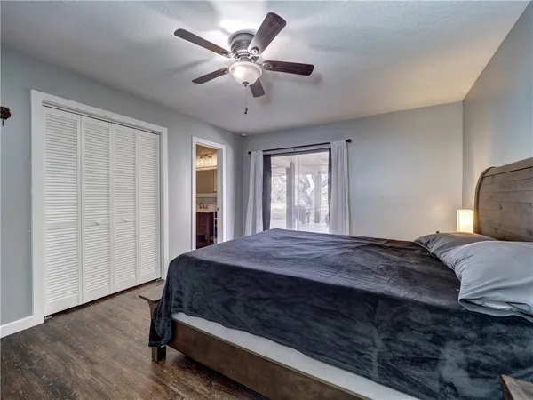 a bedroom with a large bed and a window