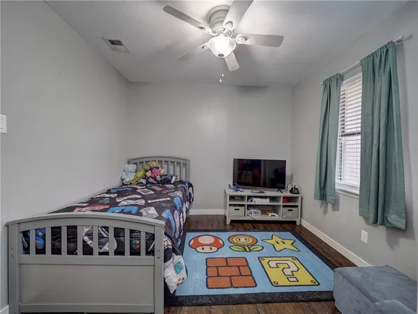 a bedroom with furniture and a flat screen tv