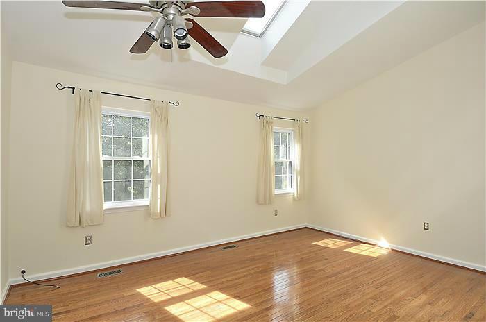 515 Pickwick Village Way Silver Spring, MD 20901 - Photo 12 of 20 a view of empty room with wooden floor and fan