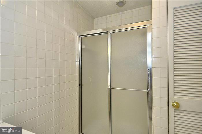 515 Pickwick Village Way Silver Spring, MD 20901 - Photo 18 of 20 a bathroom with a glass shower door