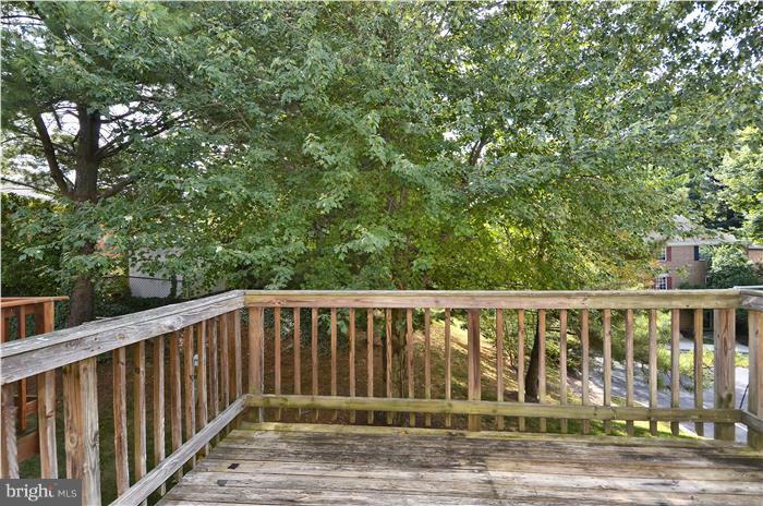 515 Pickwick Village Way Silver Spring, MD 20901 - Photo 20 of 20 a balcony with wooden floor and yard in the back