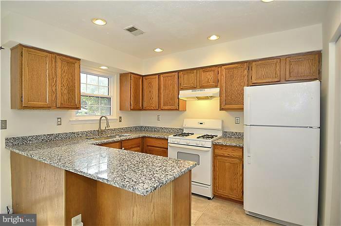 515 Pickwick Village Way Silver Spring, MD 20901 - Photo 6 of 20 a kitchen with a sink a refrigerator and cabinets