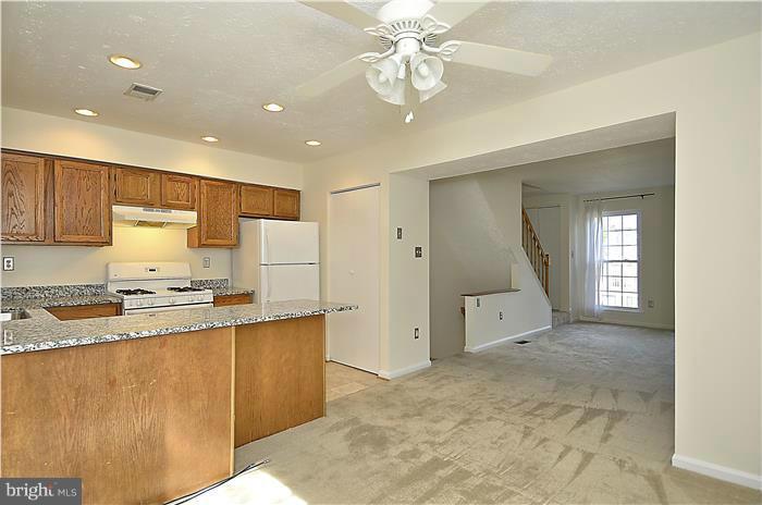 515 Pickwick Village Way Silver Spring, MD 20901 - Photo 7 of 20 a large kitchen with stainless steel appliances granite countertop a stove a sink a refrigerator and white cabinets