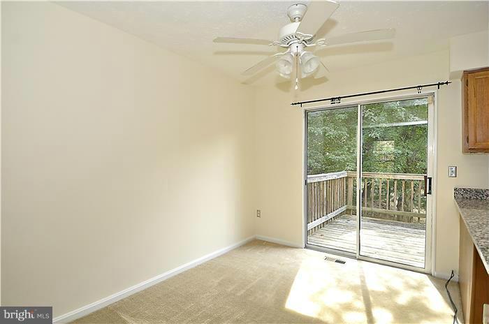 515 Pickwick Village Way Silver Spring, MD 20901 - Photo 9 of 20 a view of a livingroom with a ceiling fan and window