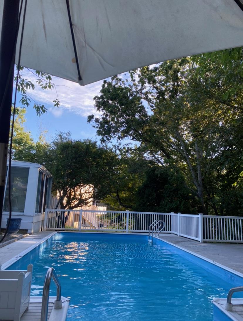 56 Nickerson Road Cotuit, MA 02635 - Photo 1 of 36 a balcony with wooden floor table and chairs