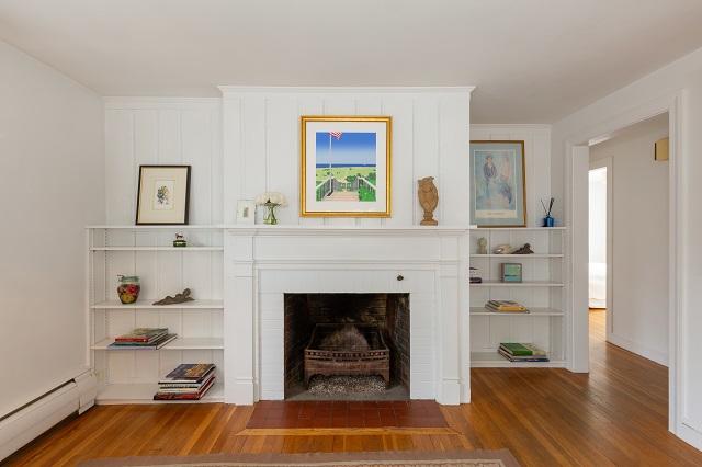56 Nickerson Road Cotuit, MA 02635 - Photo 12 of 36 a living room with furniture and a fireplace