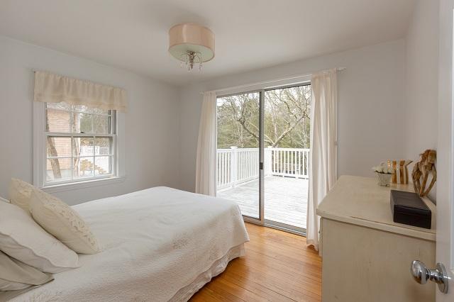 56 Nickerson Road Cotuit, MA 02635 - Photo 13 of 36 a bedroom with a bed and a large window