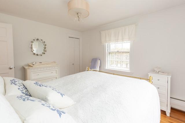 56 Nickerson Road Cotuit, MA 02635 - Photo 18 of 36 a bedroom with a bed and a window
