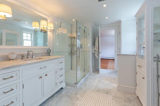 56 Nickerson Road Cotuit, MA 02635 - Photo 20 of 36 a spacious bathroom with a granite countertop sink mirror and shower