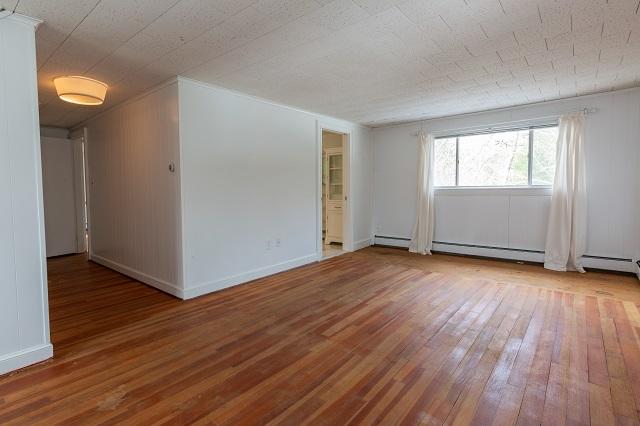 56 Nickerson Road Cotuit, MA 02635 - Photo 25 of 36 an empty room with wooden floor and a window