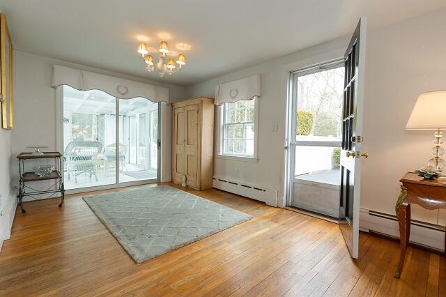 56 Nickerson Road Cotuit, MA 02635 - Photo 7 of 36 a view of an empty room with window and wooden floor