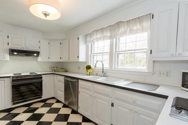 56 Nickerson Road Cotuit, MA 02635 - Photo 8 of 36 a kitchen with stainless steel appliances a sink a stove a window and cabinets