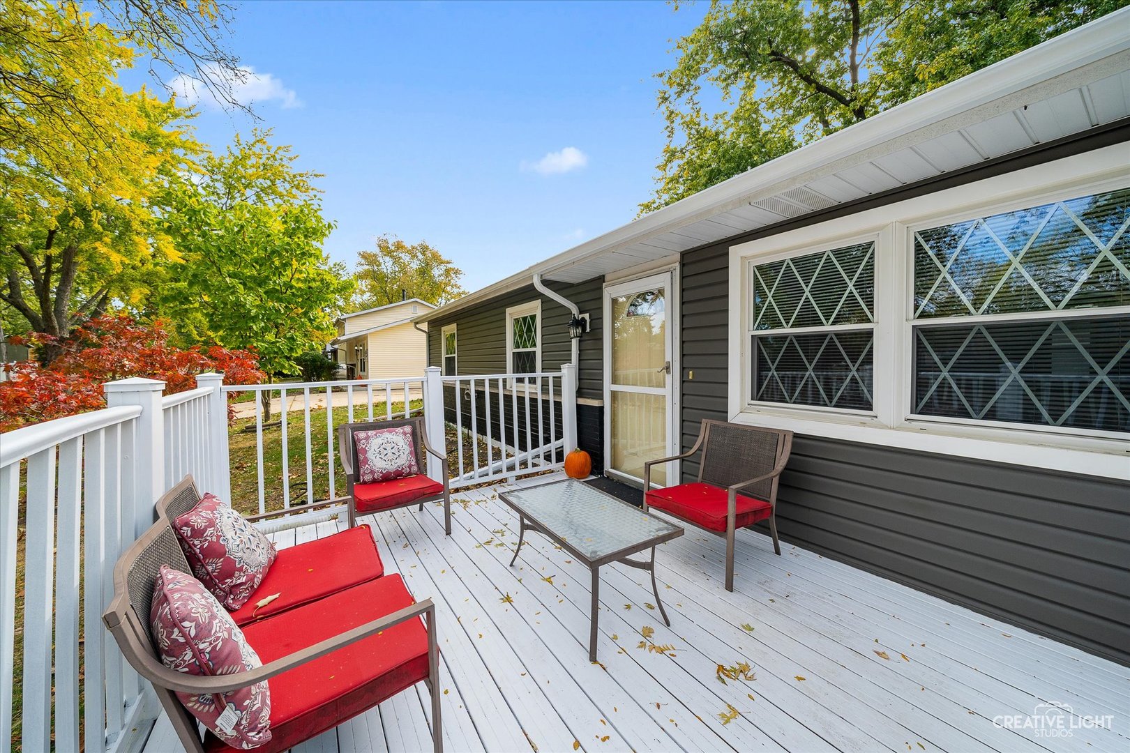 209 Hadleigh Road Bolingbrook, IL 60440 - Photo 3 of 17 a balcony with wooden floor and outdoor seating