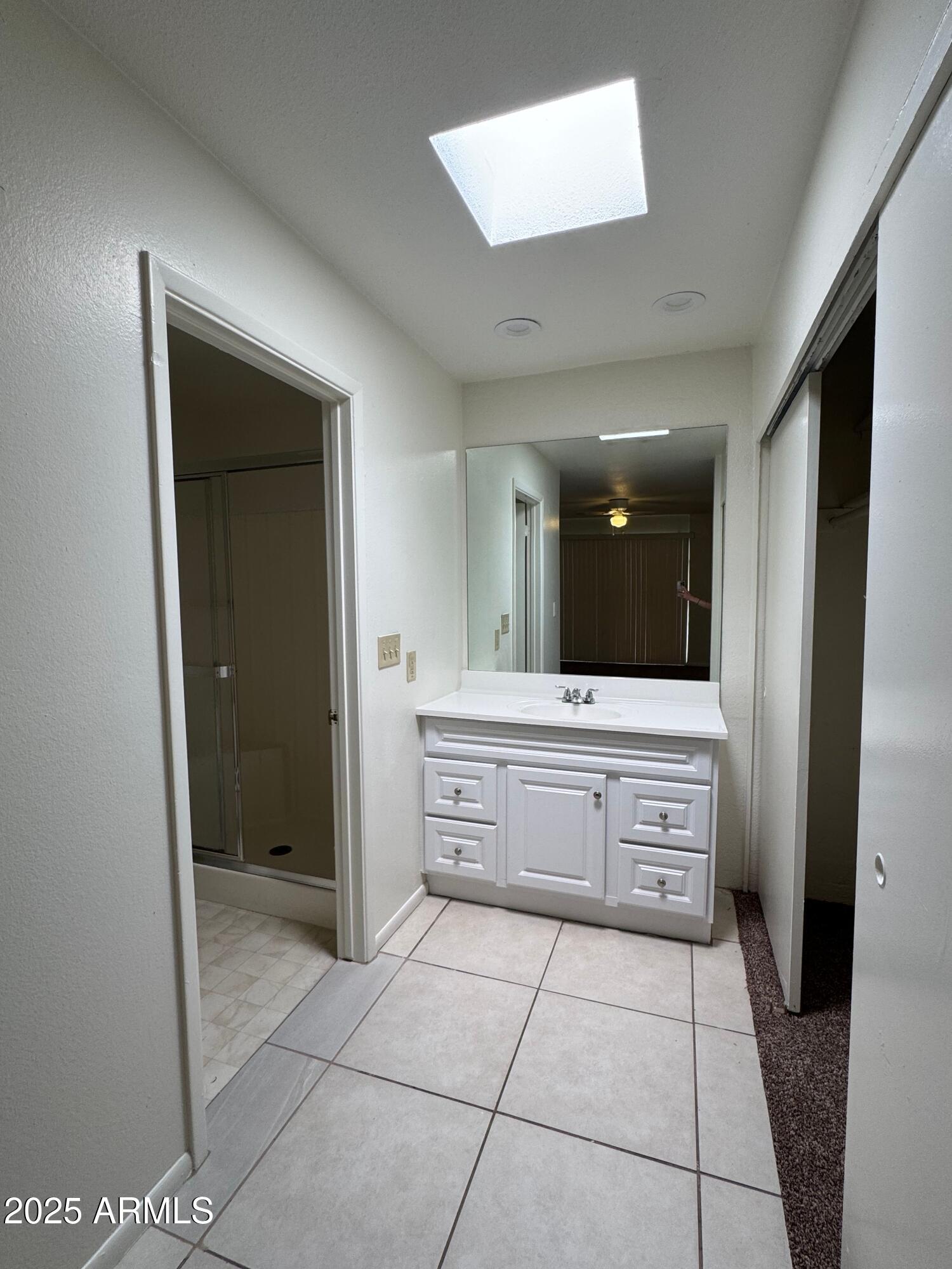 930 South Dobson Road, Unit 23 Mesa, AZ 85202 - Photo 11 of 13 a large bathroom with a large mirror vanity and a shower