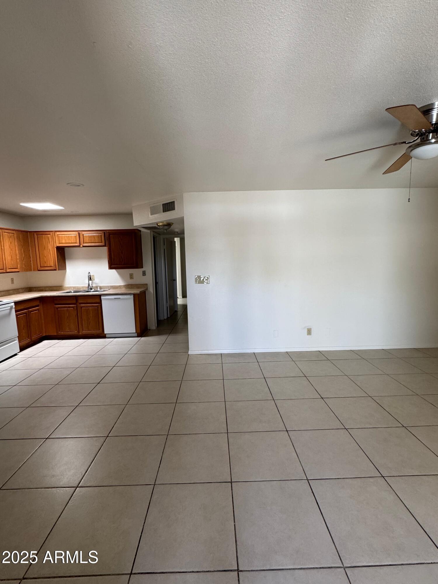 930 South Dobson Road, Unit 23 Mesa, AZ 85202 - Photo 5 of 13 a view of a kitchen with a dishwasher and a stove top oven