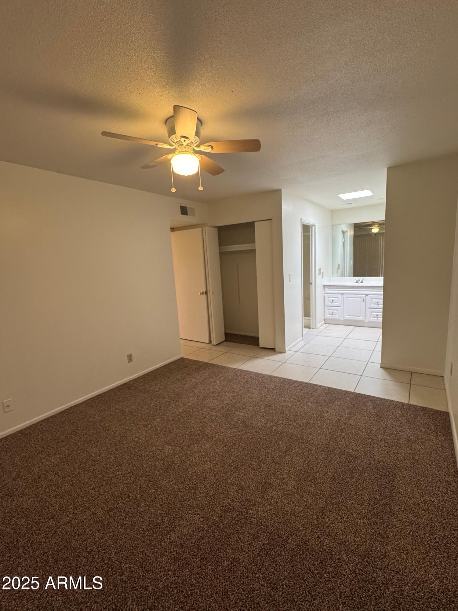930 South Dobson Road, Unit 23 Mesa, AZ 85202 - Photo 10 of 13 a view of a livingroom with a ceiling fan and window