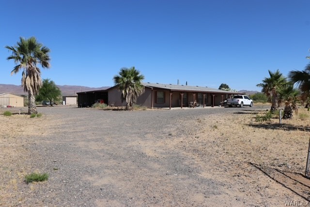 4245 Cibola Road Golden Valley, AZ 86413 - Photo 1 of 21 a view of a house with a yard