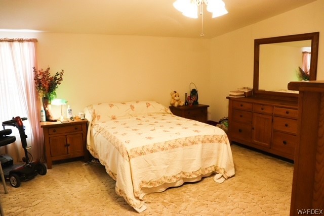 4245 Cibola Road Golden Valley, AZ 86413 - Photo 15 of 21 a bed sitting in a bedroom next to a window
