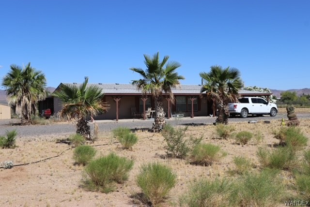 4245 Cibola Road Golden Valley, AZ 86413 - Photo 2 of 21 a view of a house with backyard and sitting area