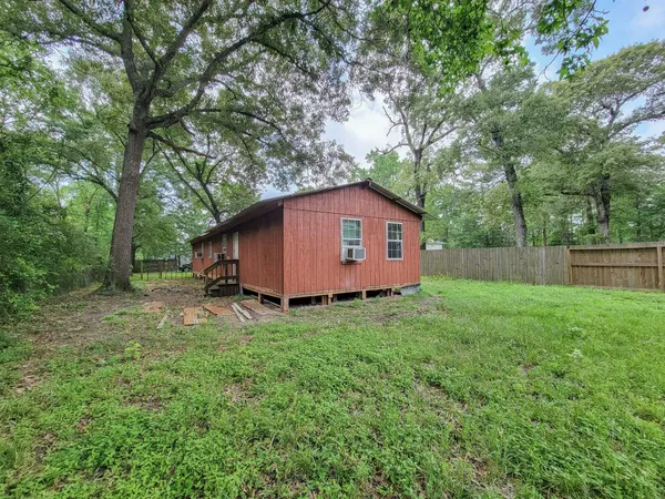 a view of backyard of house with green space