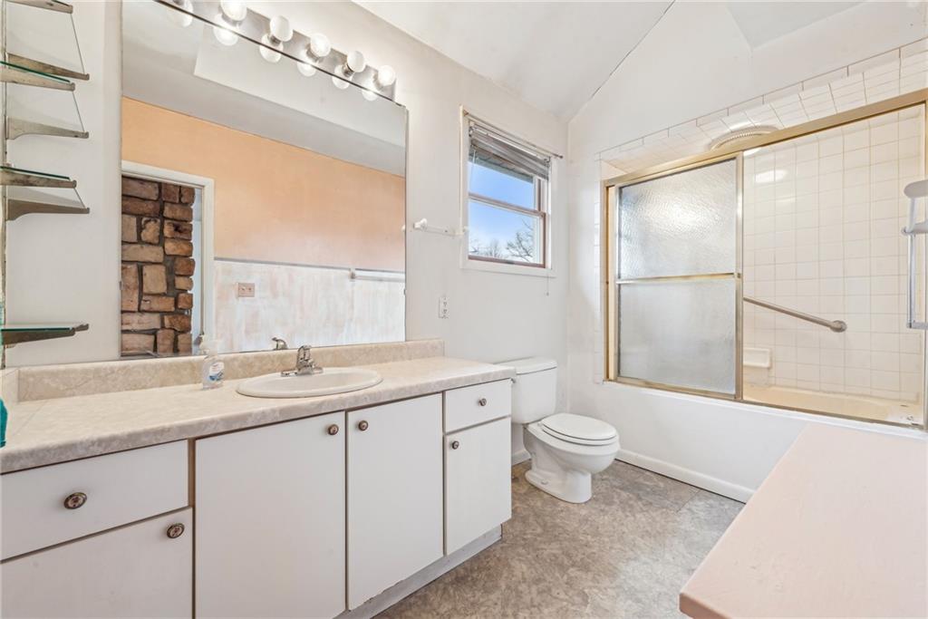 221 Woodside Road Irwin, PA 15642 - Photo 14 of 35 a bathroom with a sink a toilet a large mirror and shower