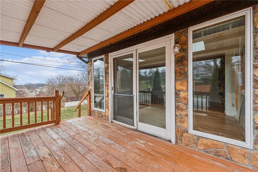 221 Woodside Road Irwin, PA 15642 - Photo 19 of 35 a view of porch with wooden floor and floor to ceiling window