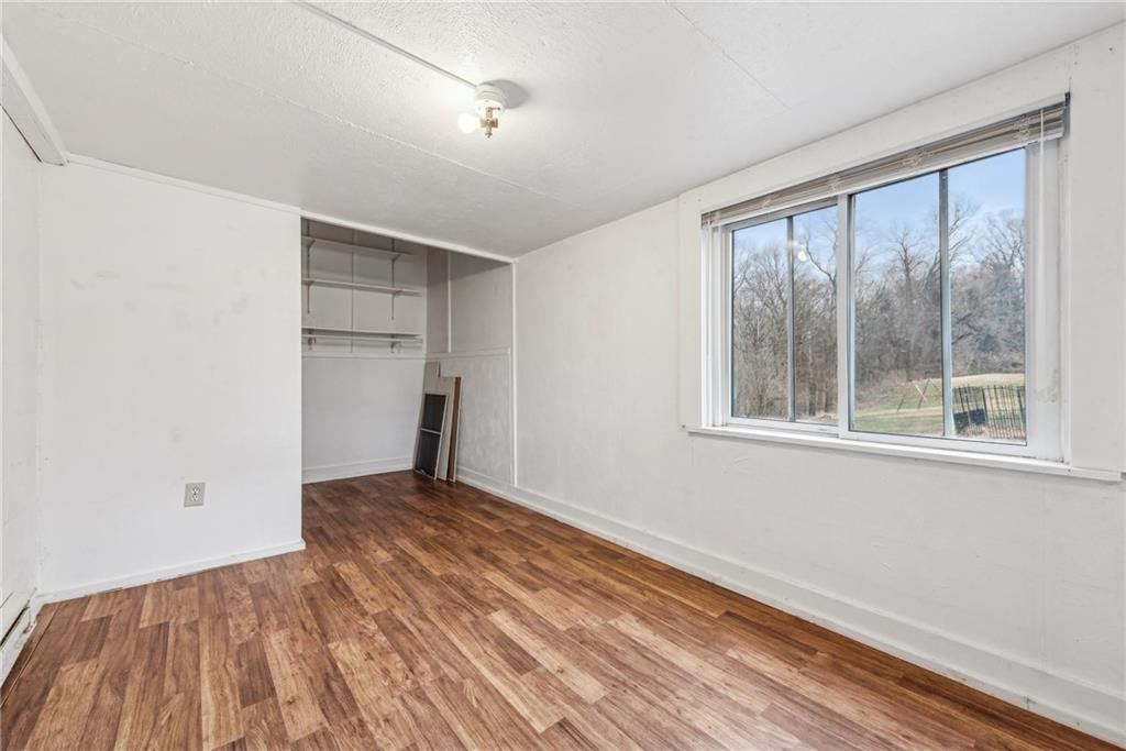 221 Woodside Road Irwin, PA 15642 - Photo 25 of 35 a view of an empty room with wooden floor and a window
