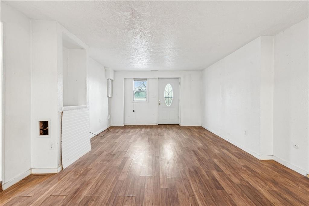 221 Woodside Road Irwin, PA 15642 - Photo 26 of 35 an empty room with wooden floor and windows