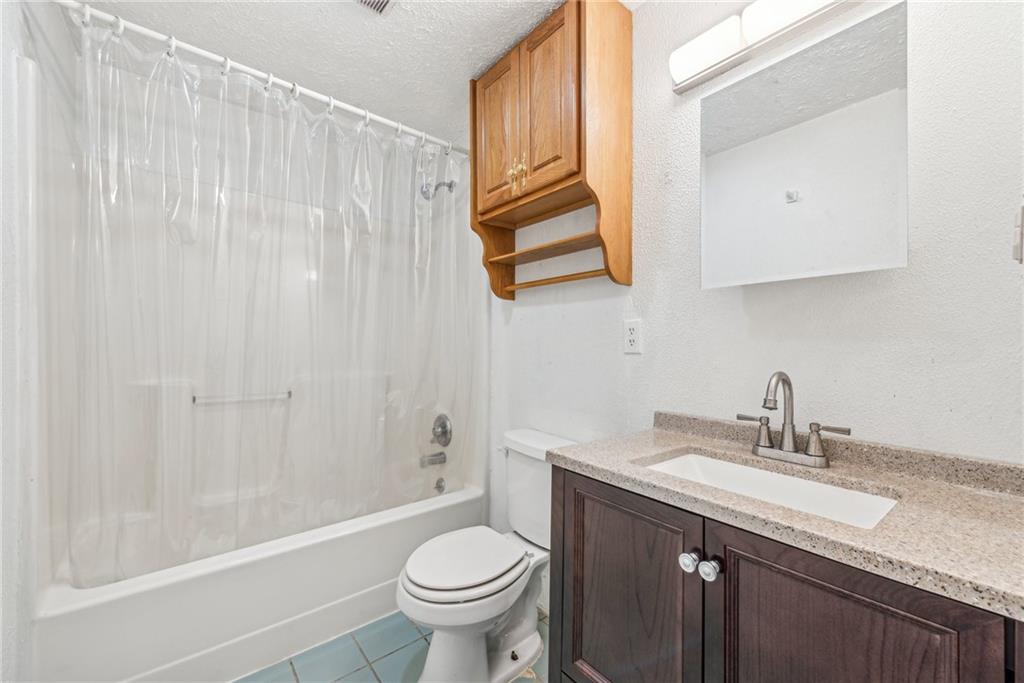 221 Woodside Road Irwin, PA 15642 - Photo 28 of 35 a bathroom with a granite countertop sink toilet and shower