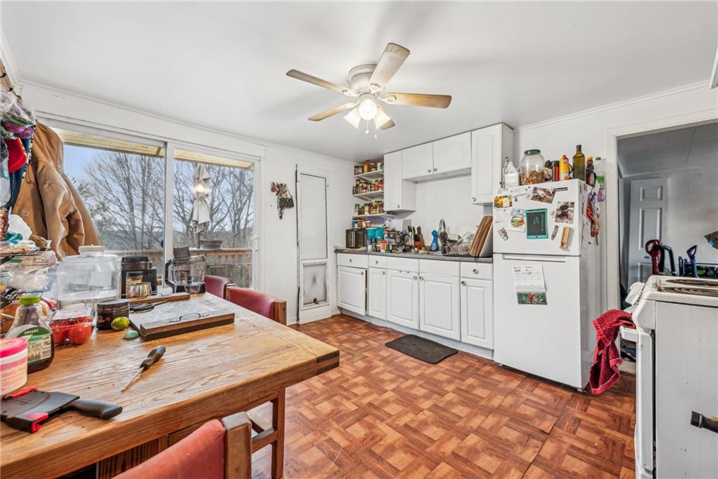 221 Woodside Road Irwin, PA 15642 - Photo 29 of 35 a kitchen with stainless steel appliances kitchen island granite countertop a sink dishwasher and cabinets with wooden floor