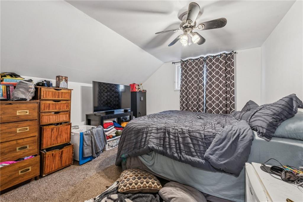 221 Woodside Road Irwin, PA 15642 - Photo 31 of 35 a bedroom with a bed and a chandelier