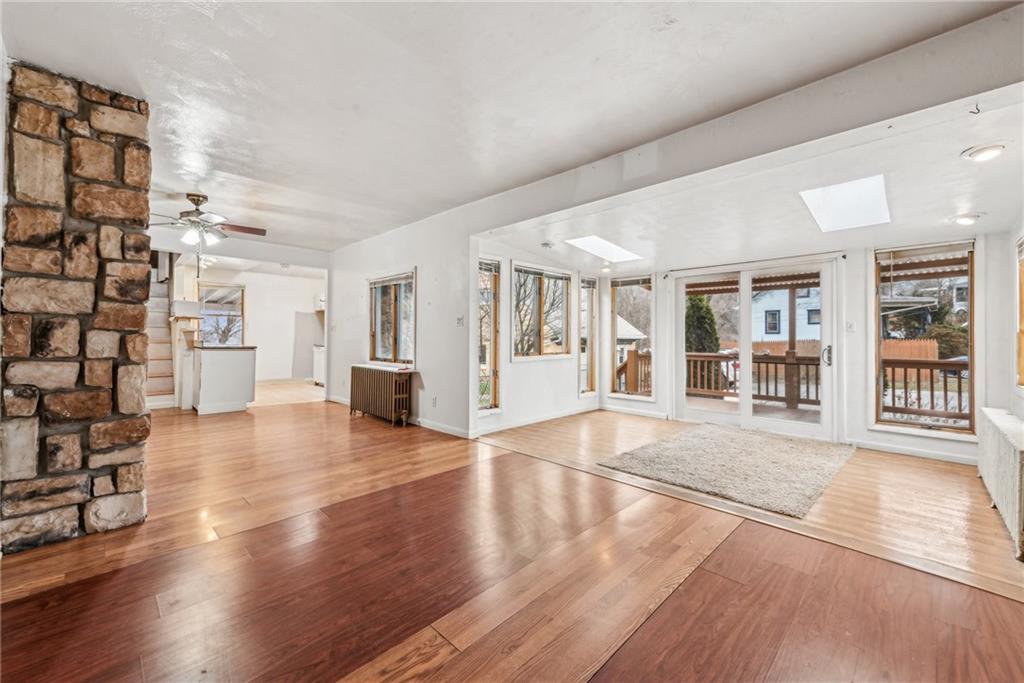 221 Woodside Road Irwin, PA 15642 - Photo 4 of 35 a view of an empty room with wooden floor and a window