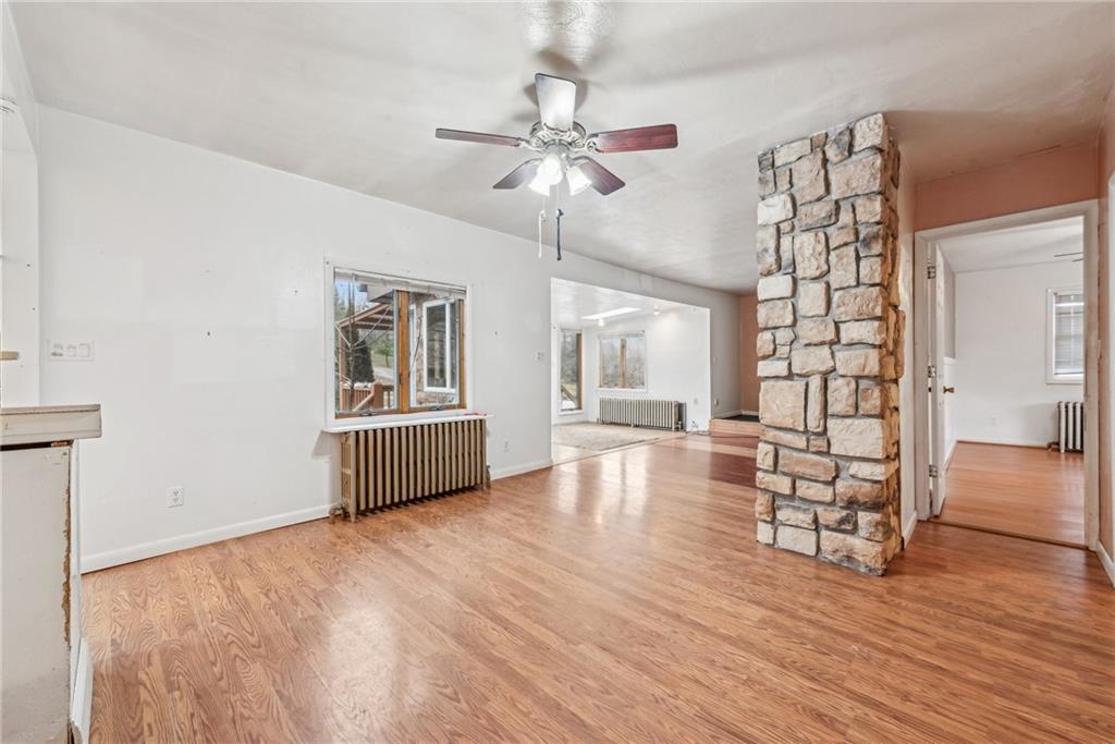 221 Woodside Road Irwin, PA 15642 - Photo 6 of 35 a living room with hard wood floors and a ceiling fan