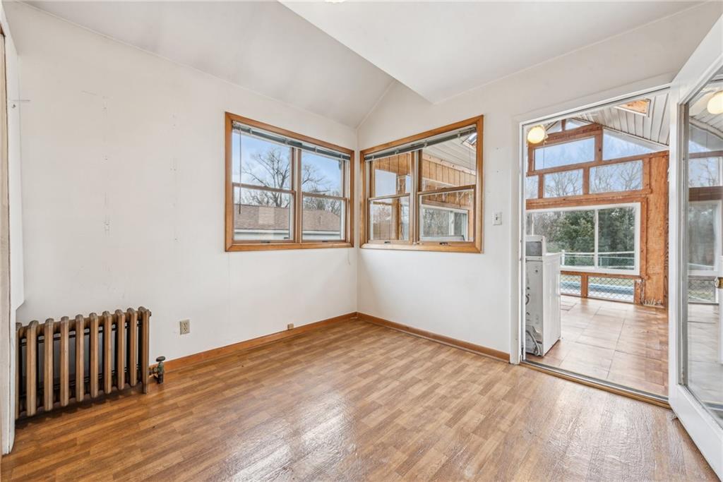 221 Woodside Road Irwin, PA 15642 - Photo 7 of 35 an empty room with wooden floor and windows