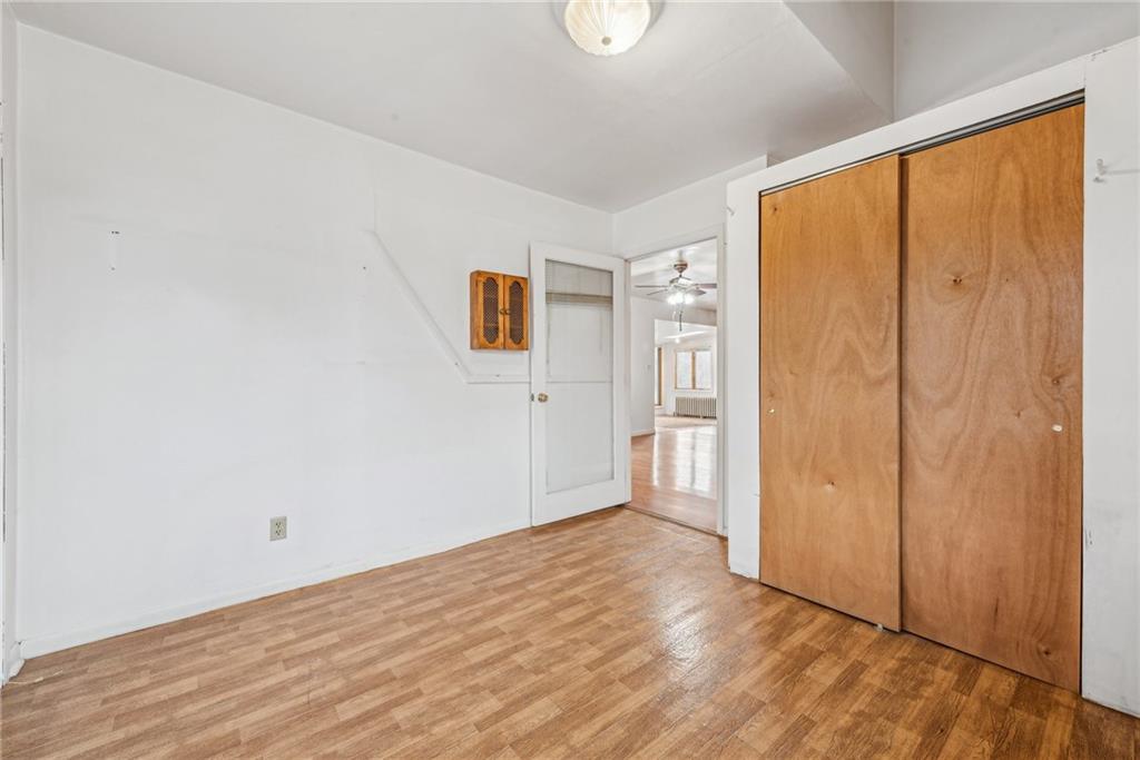 221 Woodside Road Irwin, PA 15642 - Photo 8 of 35 a view of an empty room with wooden floor and a window