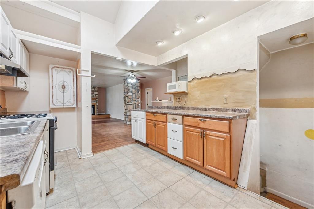 221 Woodside Road Irwin, PA 15642 - Photo 9 of 35 a large kitchen with granite countertop a large counter top and appliances