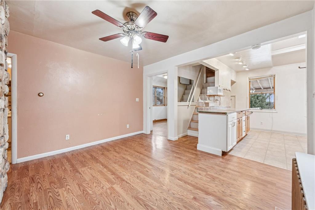 221 Woodside Road Irwin, PA 15642 - Photo 10 of 35 a view of a kitchen with wooden floor and a ceiling fan